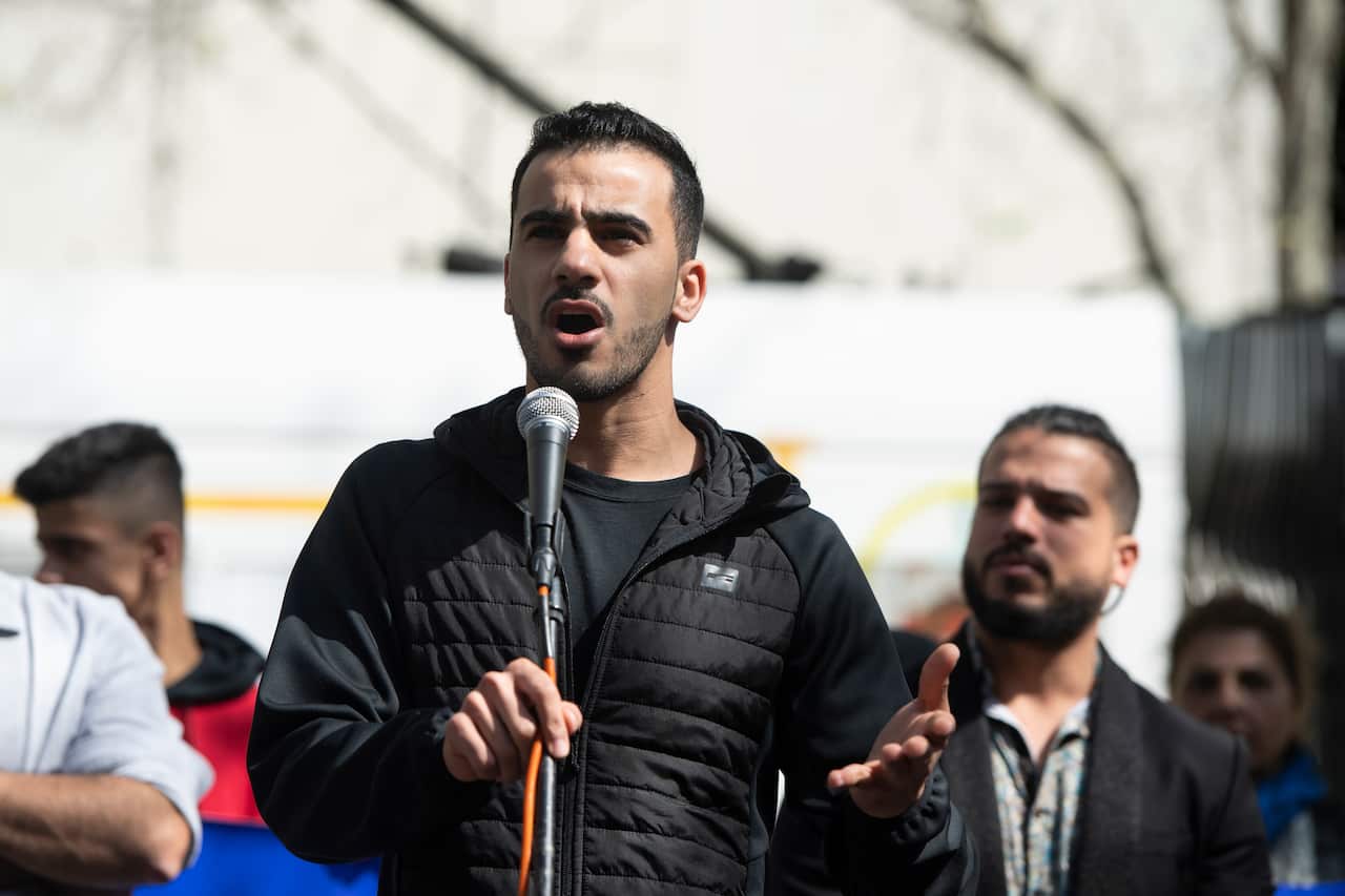 Footballer and refugee Hakeem al-Araibi speaks during a rally calling for refugee rights.