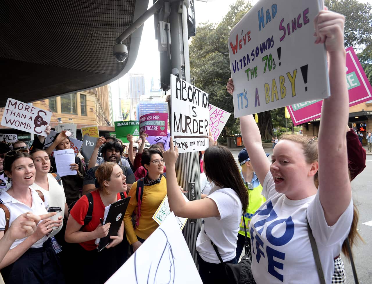 Pro-choice and anti-abortion supporters make their case after a rally in Sydney's Hyde Park.