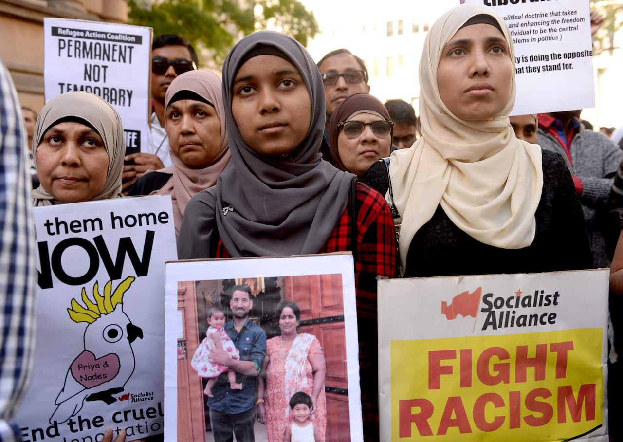 Demonstrators march through Sydney's CBD during a rally calling for refugee rights.
