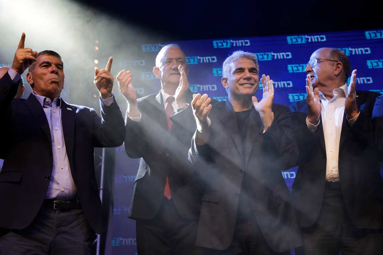 Blue and White party leaders, from the left, Gabi Ashkenazi, Benny Gantz, Yair Lapid and Moshe Ya'alon greet their supporters at party headquarters.