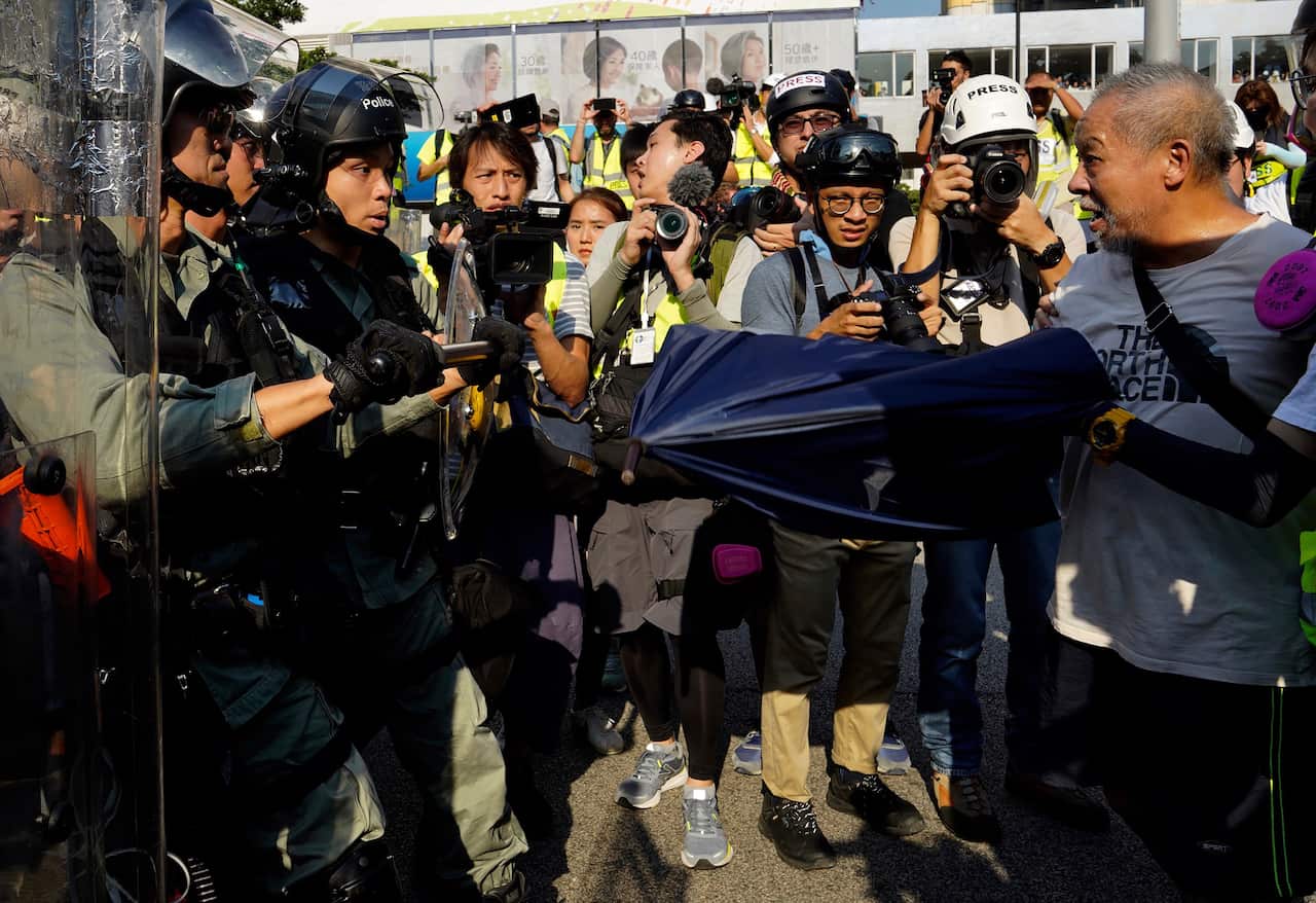 olice confronts protesters in Hong Kong.