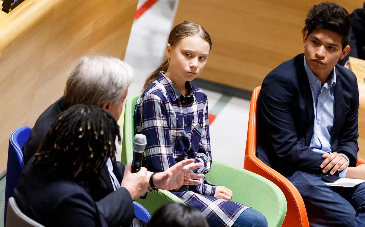 Climate activist Bruno Rodriguez (R) and sixteen-year-old climate activist Greta Thunberg listen as United Nations Secretary-General Antonio Guterres addresses the start of the United Nations Youth Climate Summit in New York, 21 September 2019. 