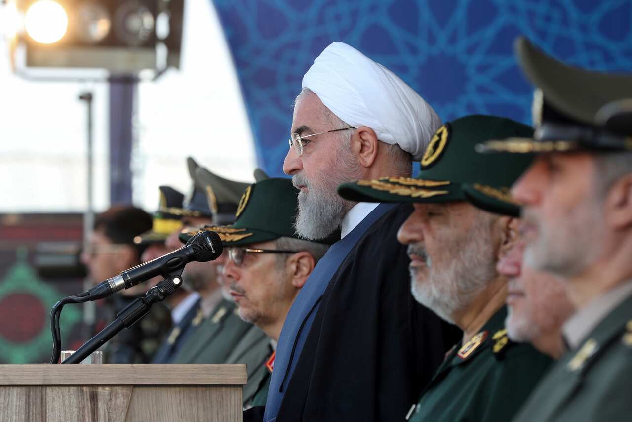 President Hassan Rouhani reviews a military parade marking 39th anniversary of outset of Iran-Iraq war.