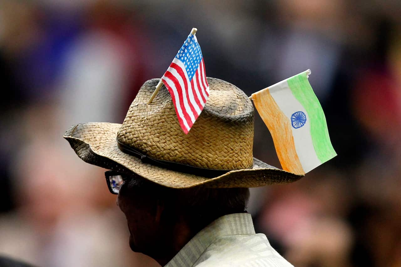 A guest wears the India and United States flags at the event hosted by the Texas India Forum.  