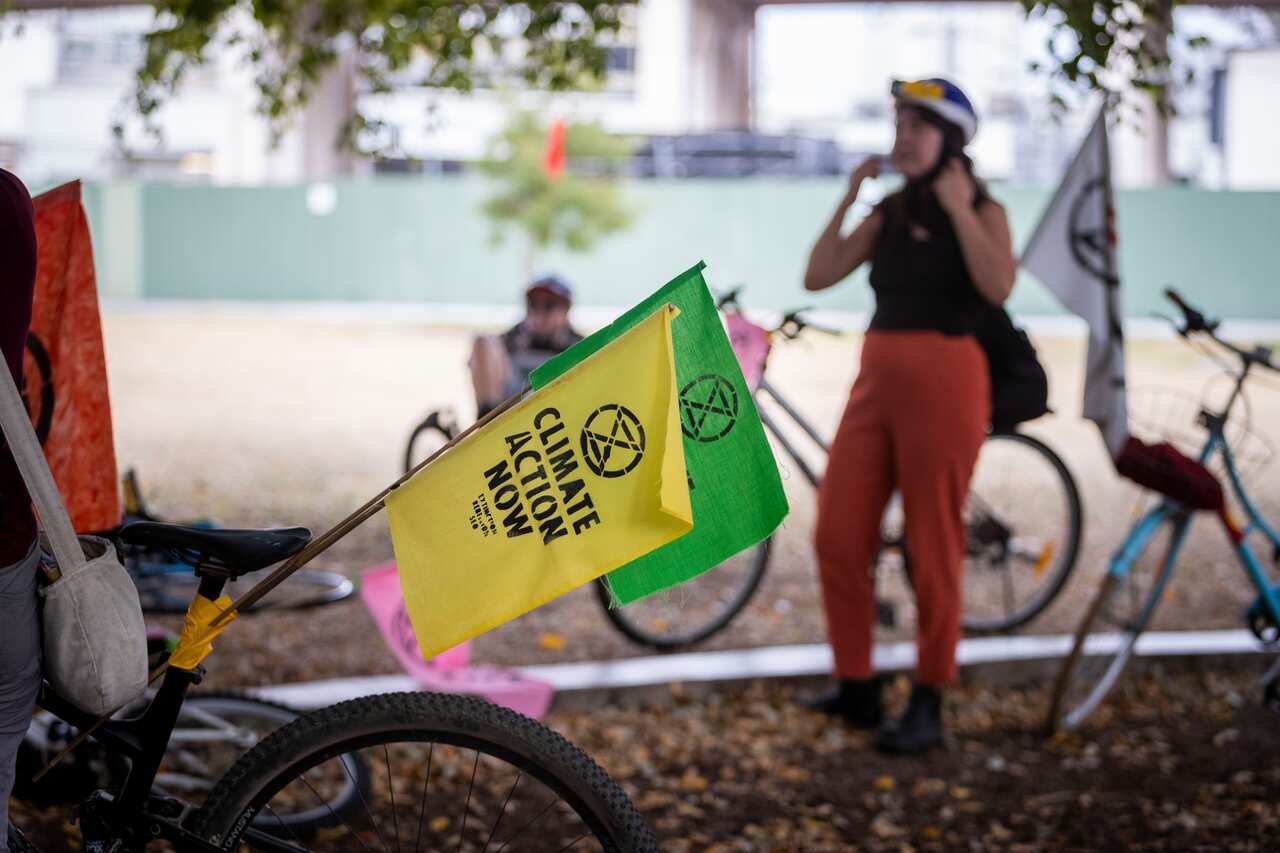 Extinction Rebellion protestors on bicycles are seen during a rally in Brisbane.