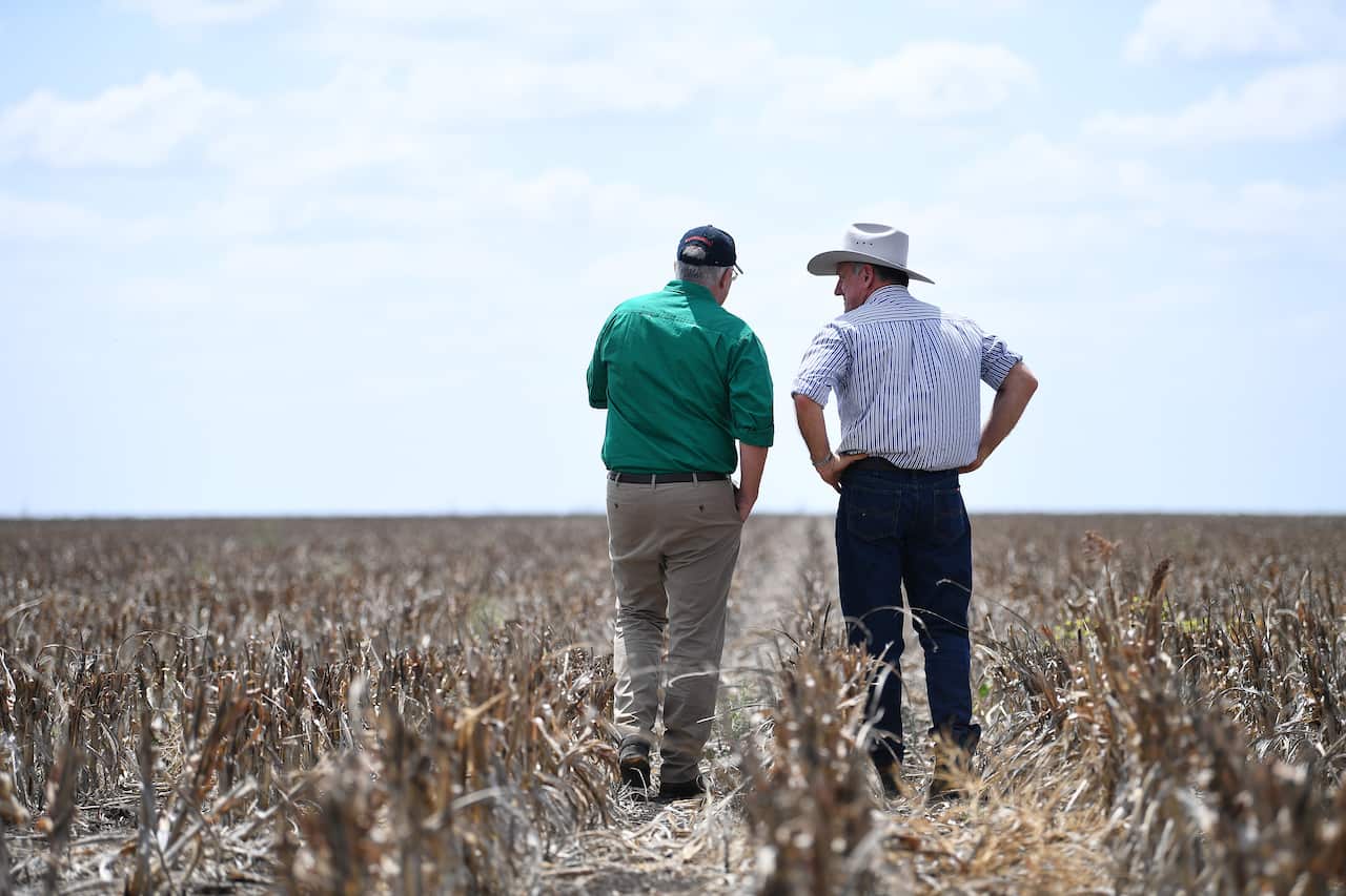 Prime Minister Scott Morrison (left) chats to farmer David Gooding on his drought-affected property.