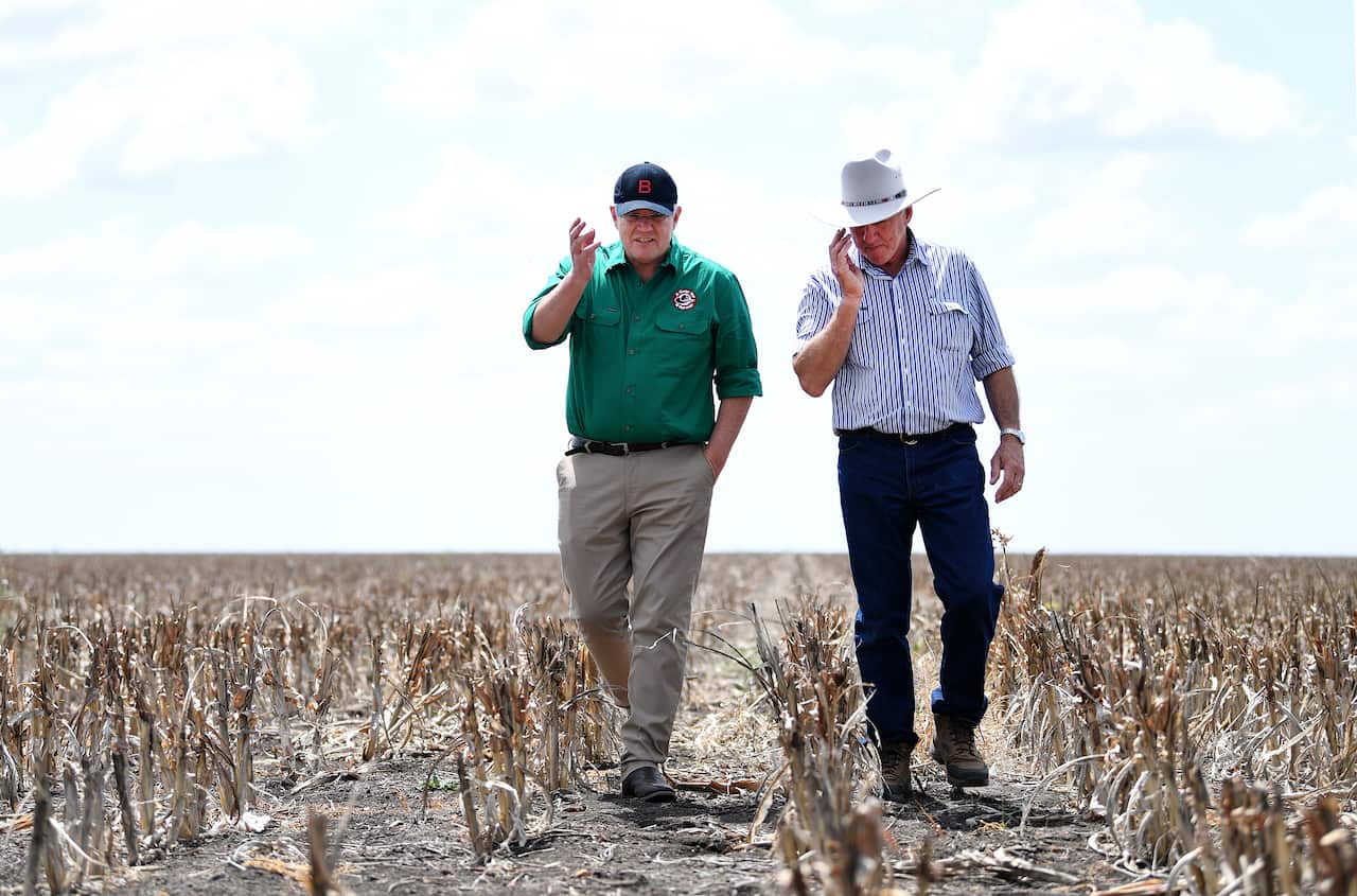 Prime Minister Morrison walks through the farm in Dalby, Queensland.  
