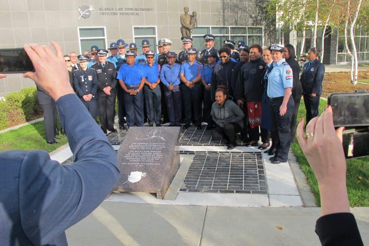 Law enforcement representatives from Australia, New Zealand and Papua New Guinea pose with their Alaska counterparts after a police remembrance ceremony.