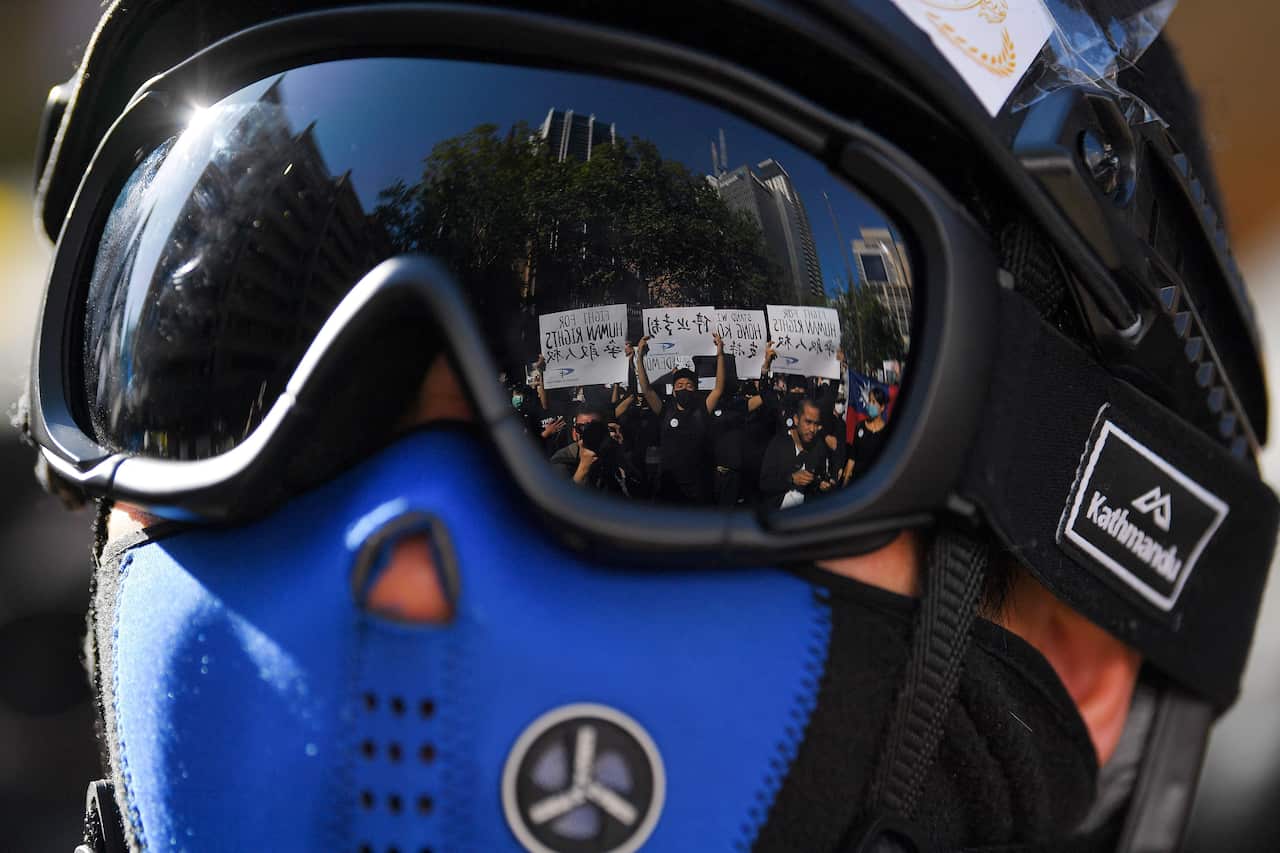 Pro-democracy supporters are reflected in a pair of goggles during a Hong Kong pro-democracy demonstration in Sydney.