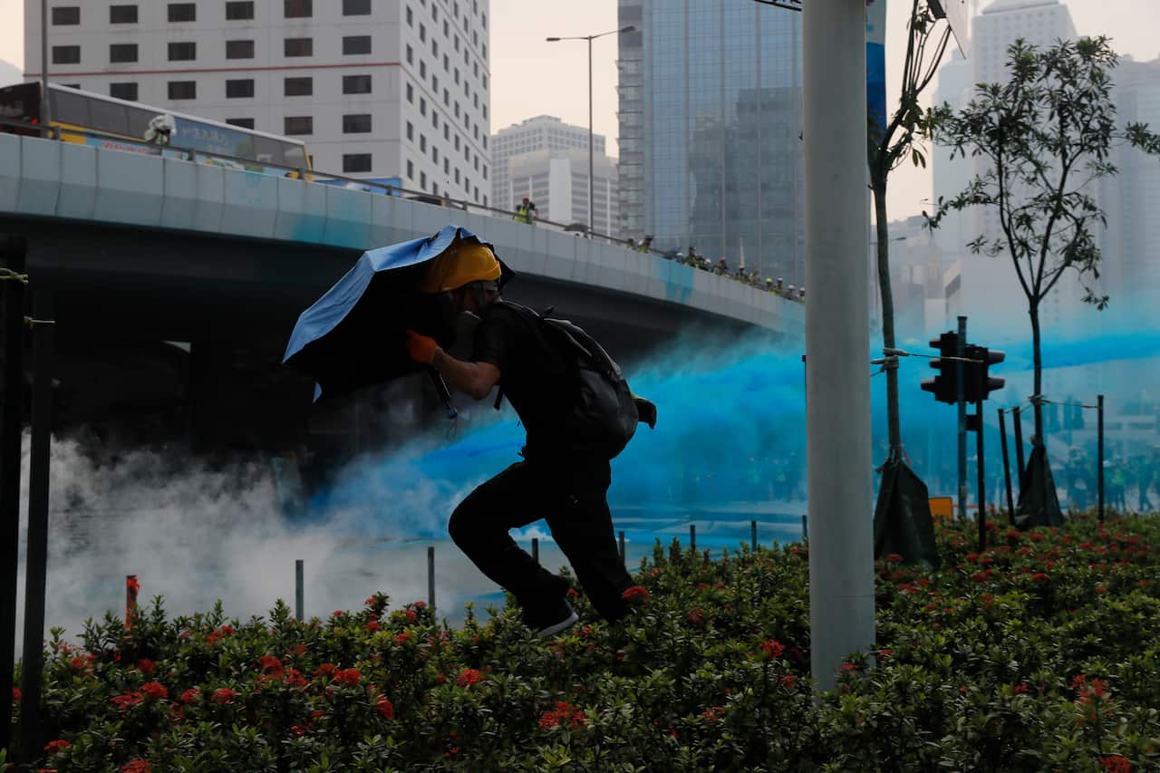 Police use blue coluored water on protestors in Hong Kong on Sunday.