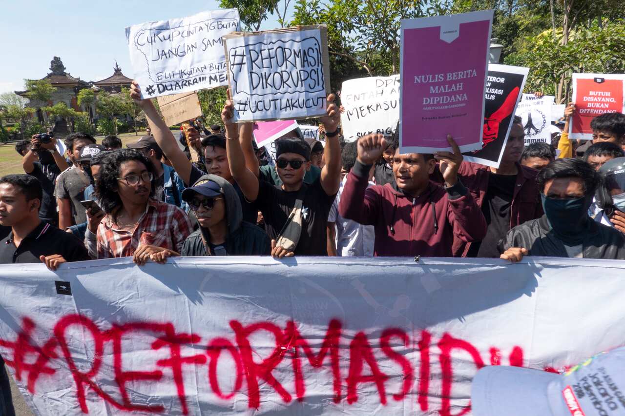 Indonesian students hold placards during a protest.