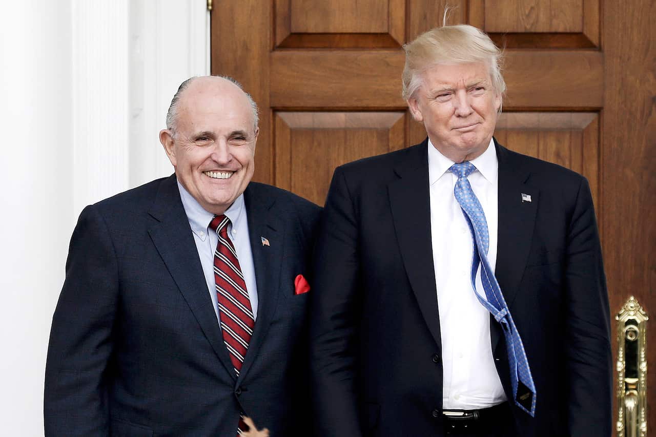 Rudy Giuliani (left) poses with US President Donald Trump.