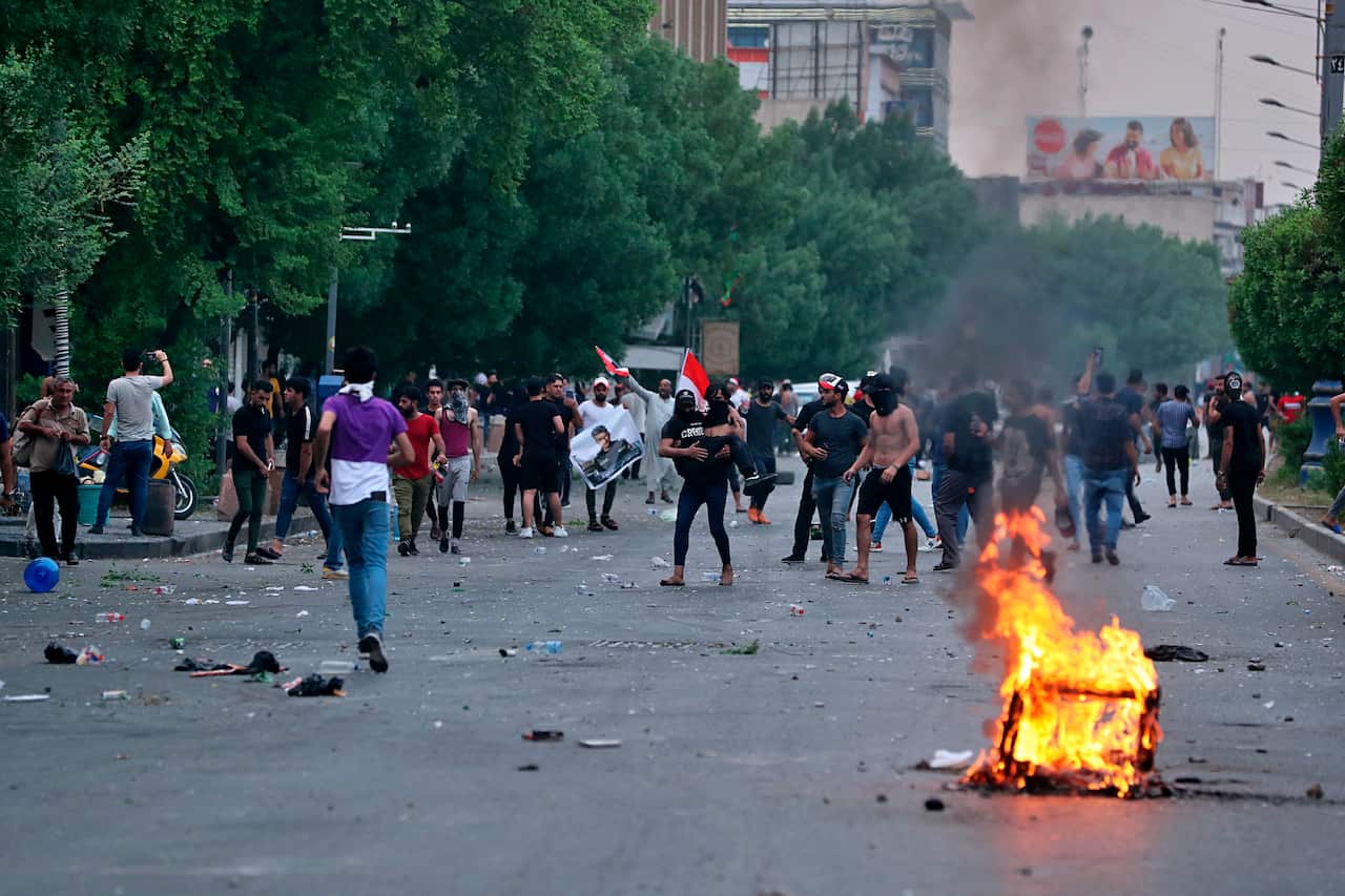 Protesters burn tires during a demonstration in Baghdad, Iraq, Tuesday, Oct. 1, 2019. Iraq officials say 1 person has been killed and 200 injured in confrontations between anti-government protesters and security forces in Baghdad. (AP Photo/Hadi Mizban)