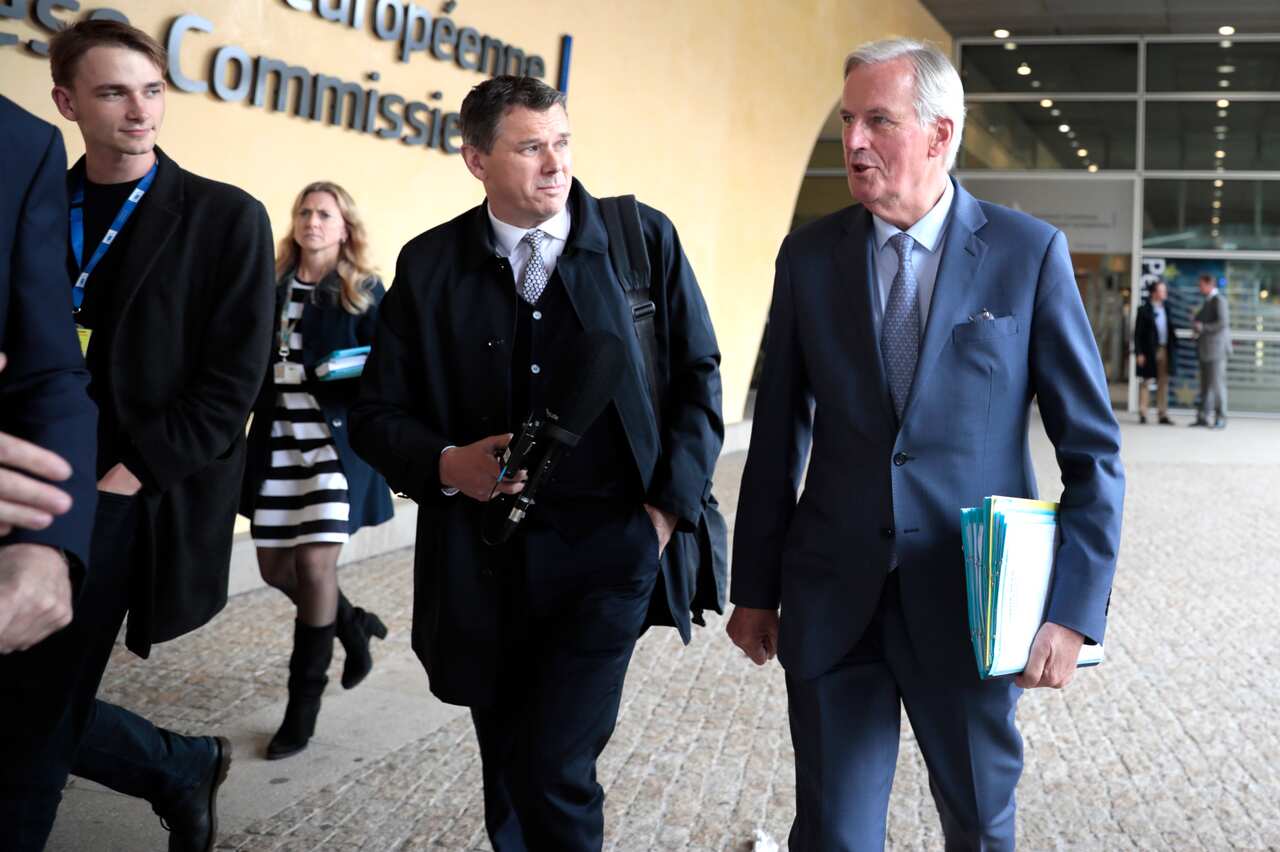 European Union chief Brexit negotiator Michel Barnier, right, walks out of EU headquarters in Brussels, on October 3. 