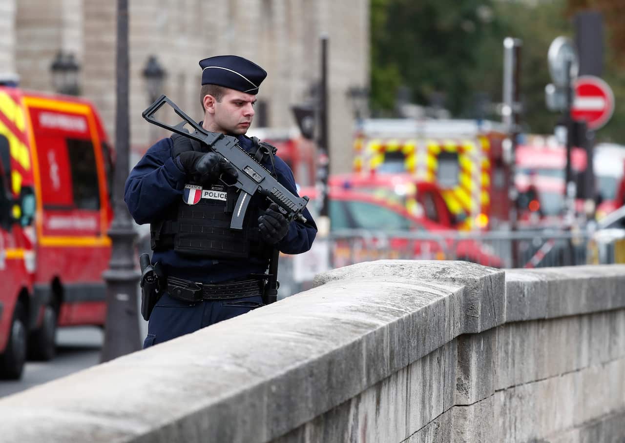 French police and security forces on guard where a man was attacking officers with a knife.