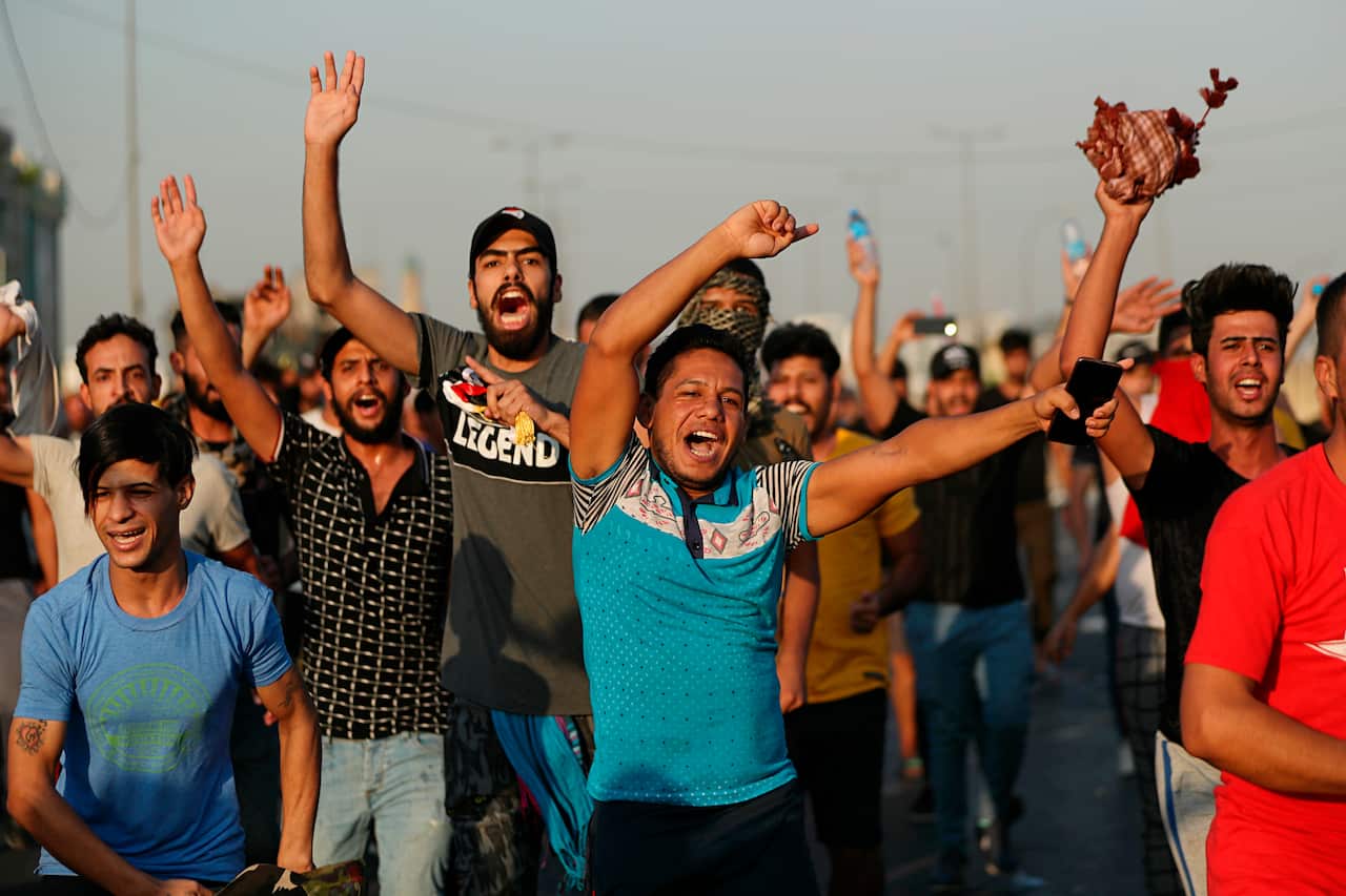 Anti-government protesters chant slogans while walking towards the protest site area during a demonstration in Baghdad, Iraq.