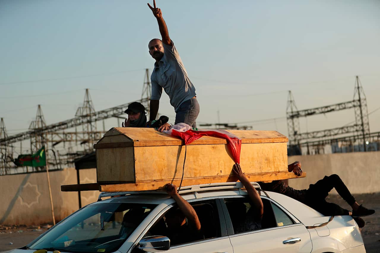 People carry the coffin of a protester killed during a demonstration in Baghdad, Iraq.
