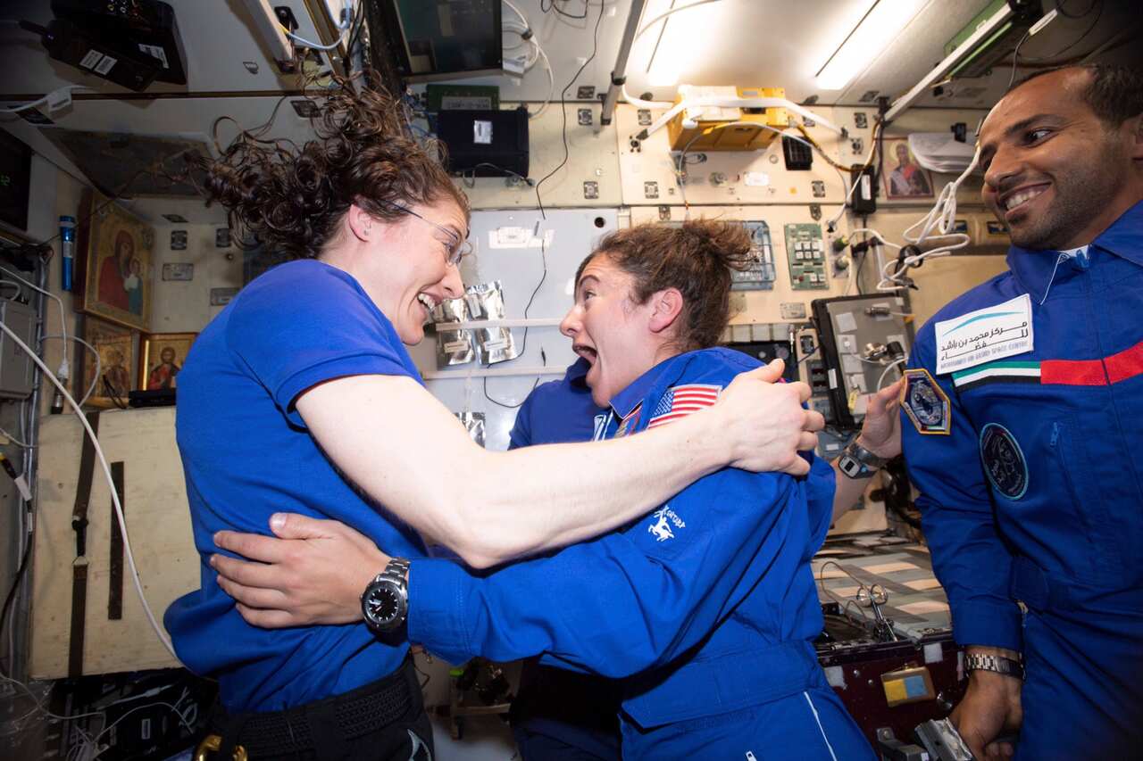 Astronauts Jessica Meir and Christina Koch greet each other after Ms Meir's arrival on the International Space Station. 