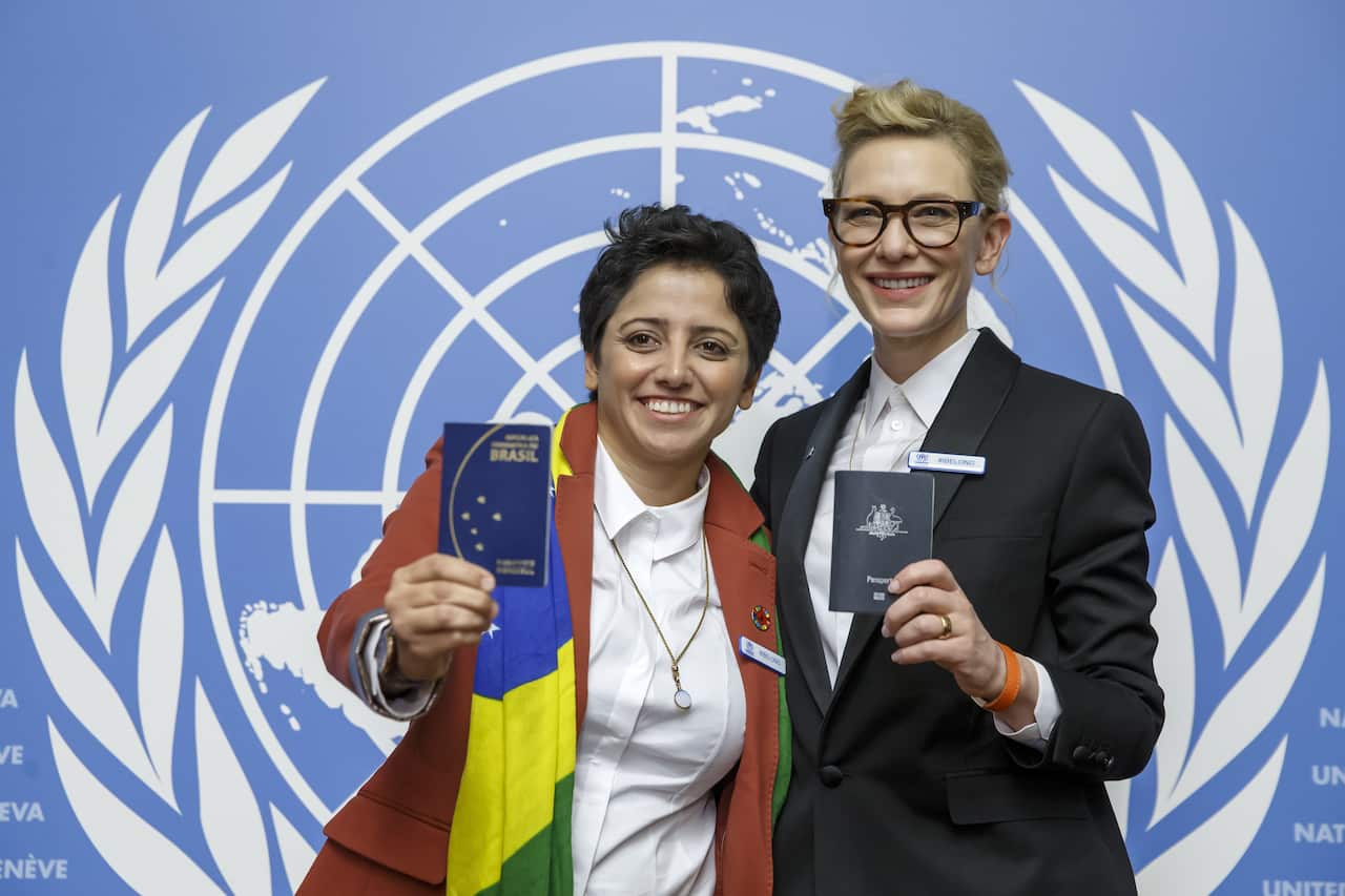 Australian actress and UNHCR goodwill ambassador Cate Blanchett, right, and Maha Mamo, left, former stateless refugee, show their passports.