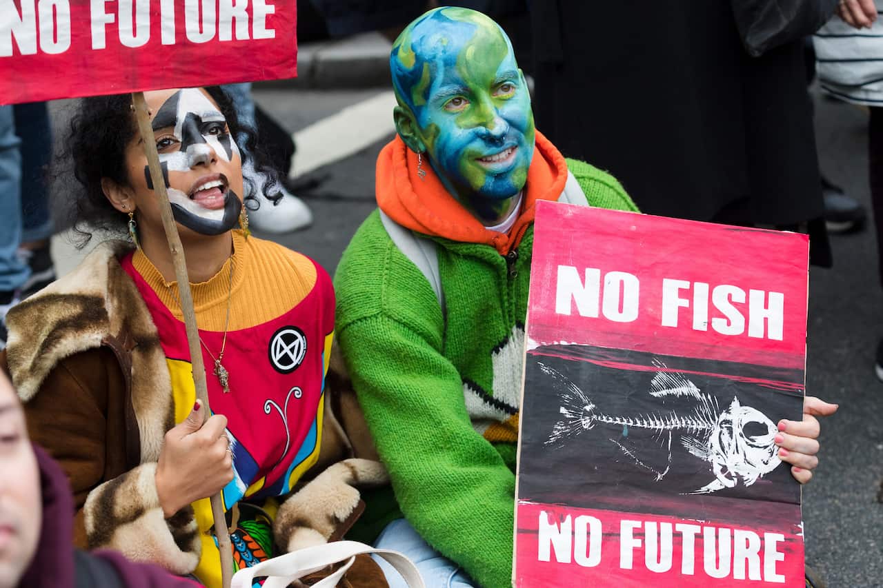 Extinction Rebellion protesters rally in Trafalgar Square in London.
