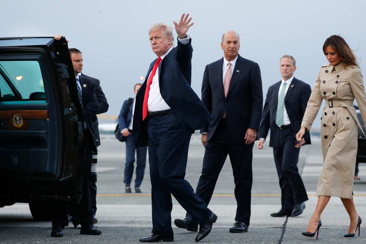President Donald Trump walks with the US ambassador to the European Union, Gordon Sondland, second from the right, on the tarmac.