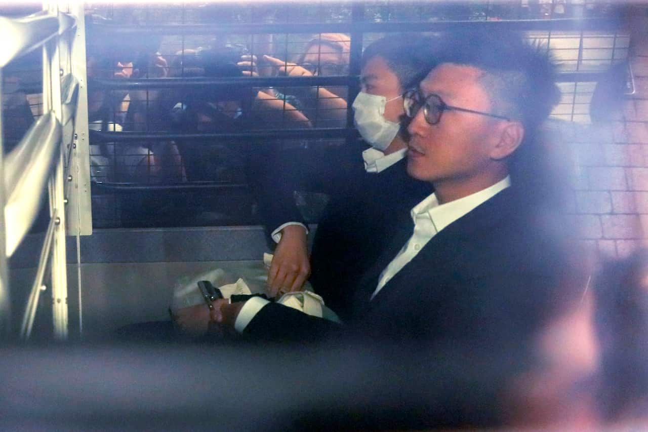 Hong Kong Jailed activist Edward Leung, right, is escorted by Correctional Services officers in a prison van as he arrives high court for his sentence appeal.