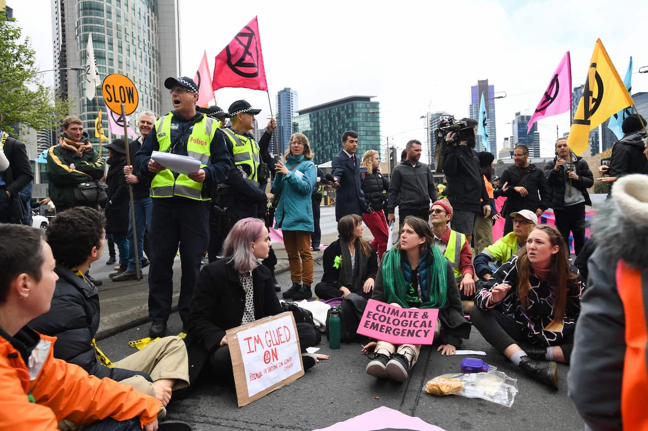 Police warn activists from Extinction Rebellion of arrests during a protest in Melbourne on Thursday.
