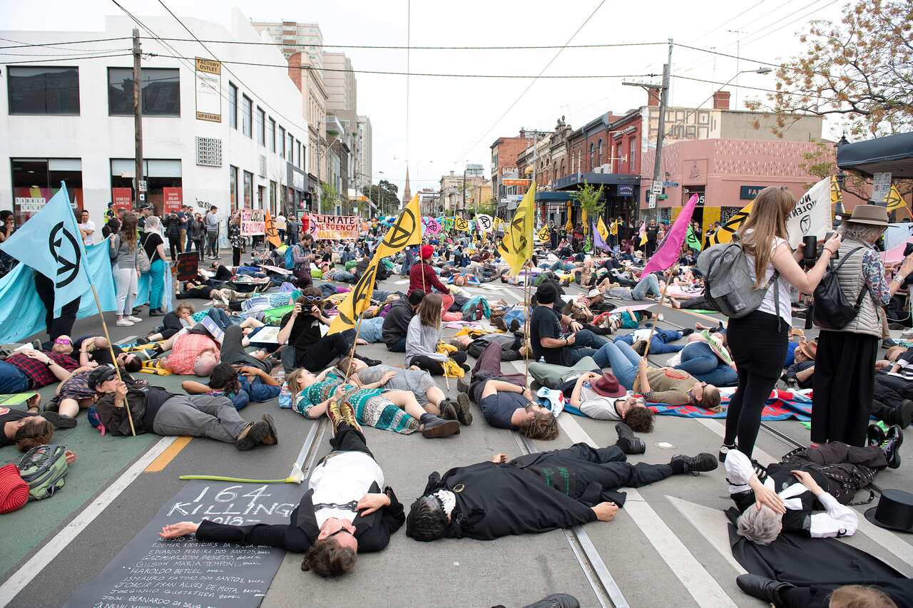 Extinction Rebellion activists lie down on the road.