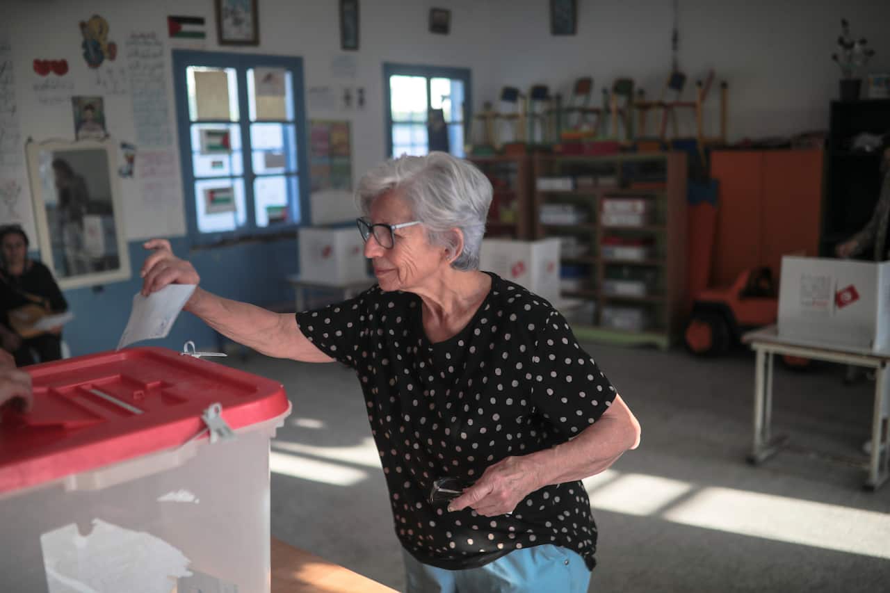 A voter casts her ballot.