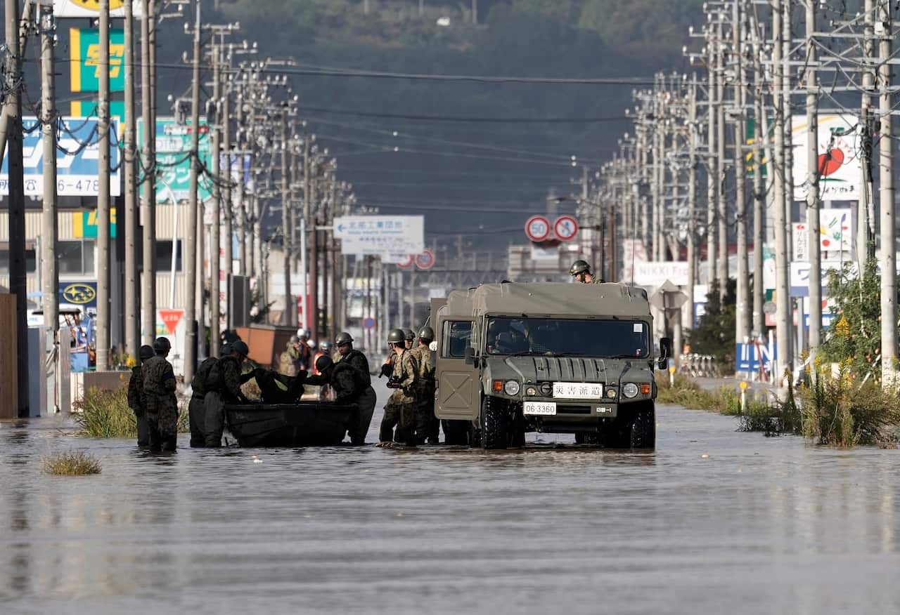 Japan's Self-Defense Force's vehicles and personnel prepare for a rescue operation at a  typhoon Hagibis flooded area in Nagano.