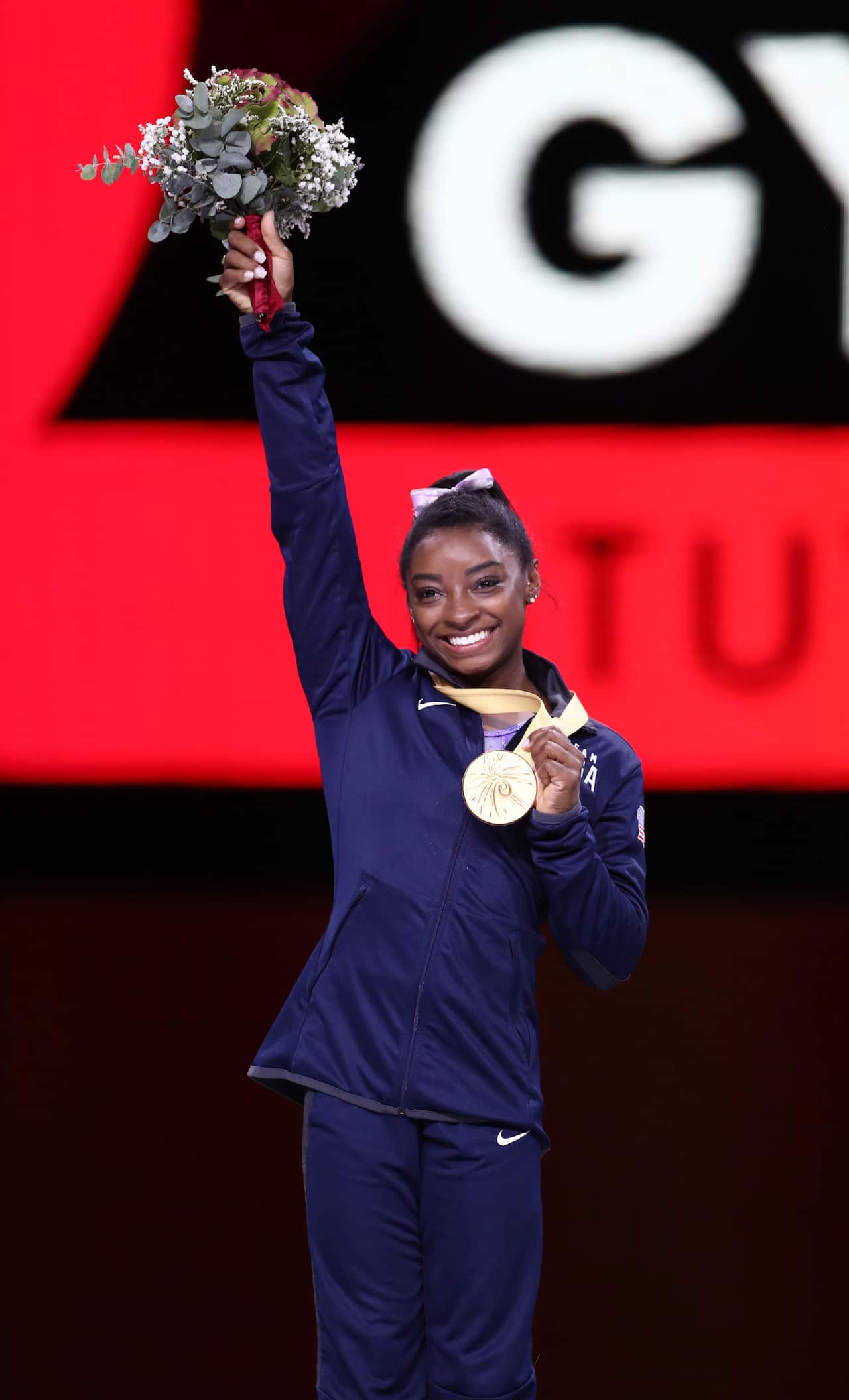 Simone Biles celebrates on the podium at the World Artistic Gymnastics Championships in Stuttgart, Germany.