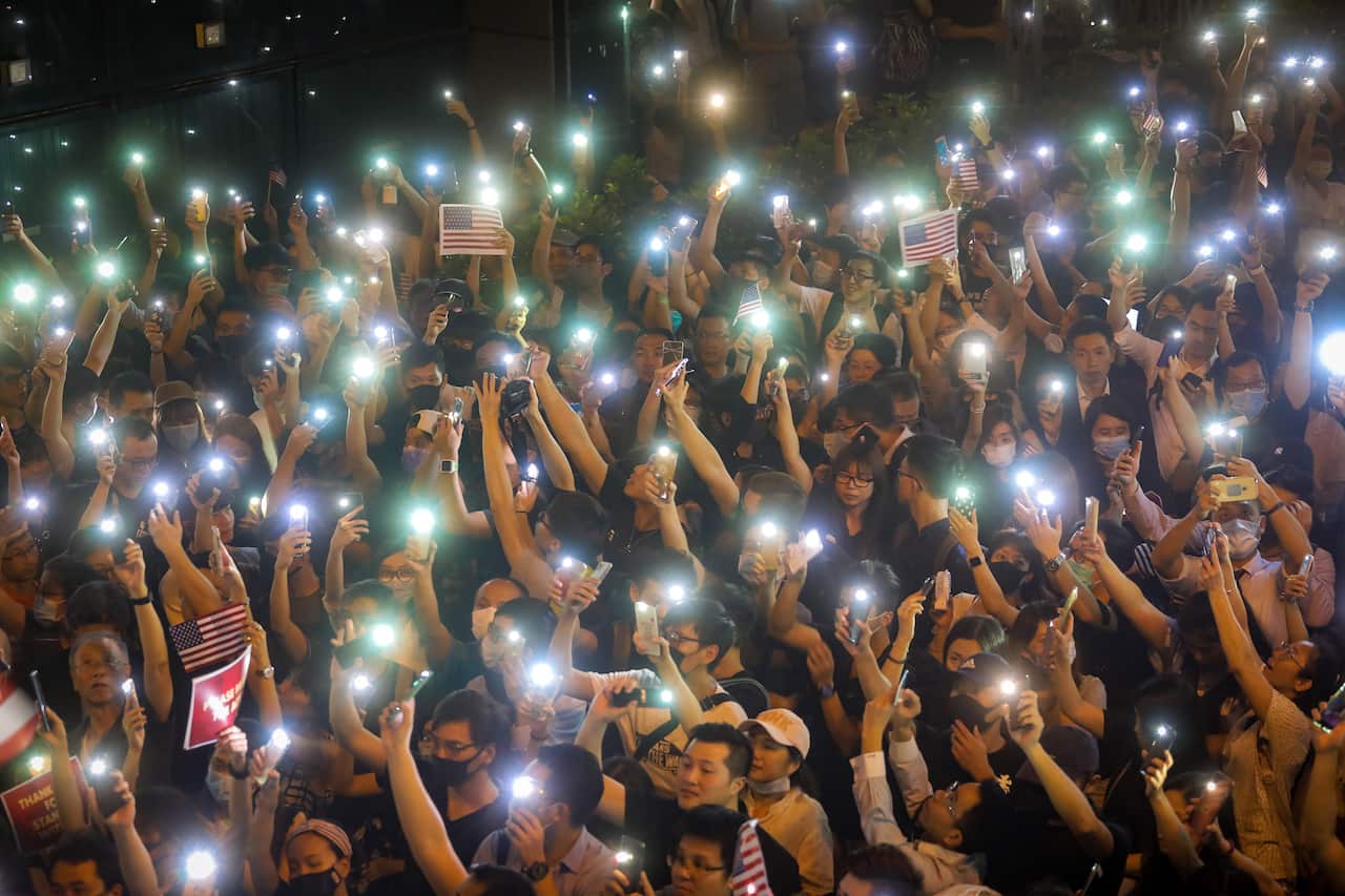 Protesters hold up the flashlights of their cellphones at a rally at Chater Garden in the the Central district in Hong Kong, China, 14 October 2019. 
