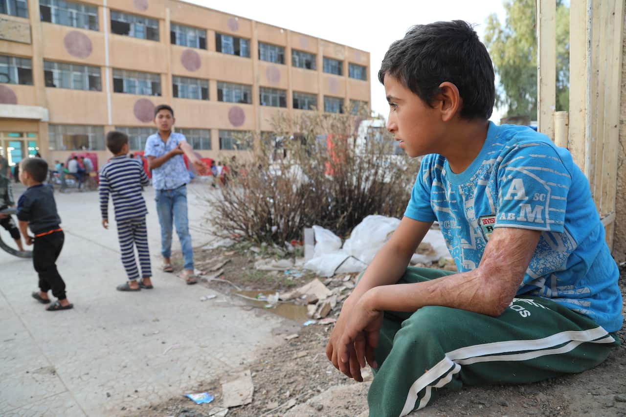 Displaced Kurdish children who fled their home town of Ras al-Ain city play at temporary shelter in a school building at Tal Tamr town, northeast of Syria.