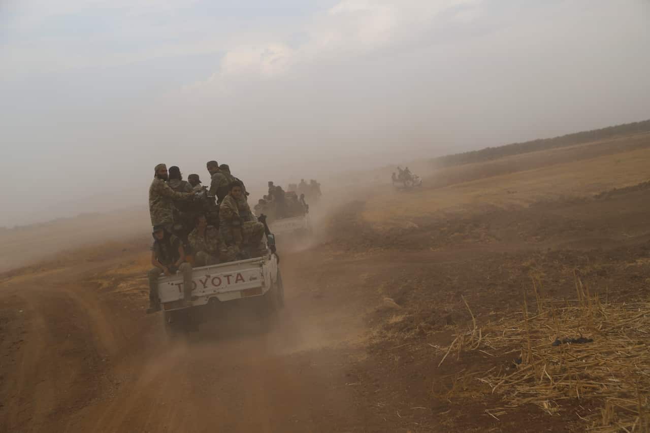 A convoy of Turkish backed Free Syria Army is about to cross into Turkey near the town of Azaz, Syria, Wednesday, Oct. 16, 2019. (AP Photo)