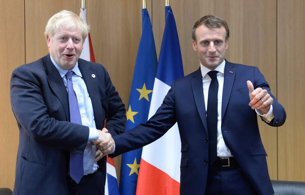 Britain's Prime Minister Boris Johnson poses with French President Emmanuel Macron during a European Union leaders summit in Brussels, October 17, 2019.