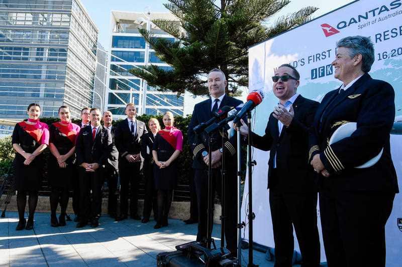 Qantas Group CEO Alan Joyce (second right) speaks to the media during a press conference at Sydney International Airport