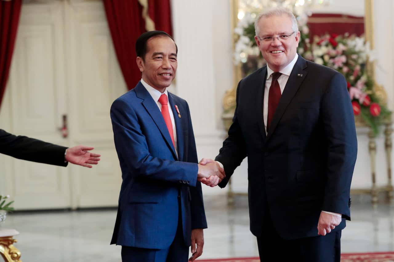 Indonesian President Joko Widodo, left, shakes hands with Prime Minister Scott Morrison.