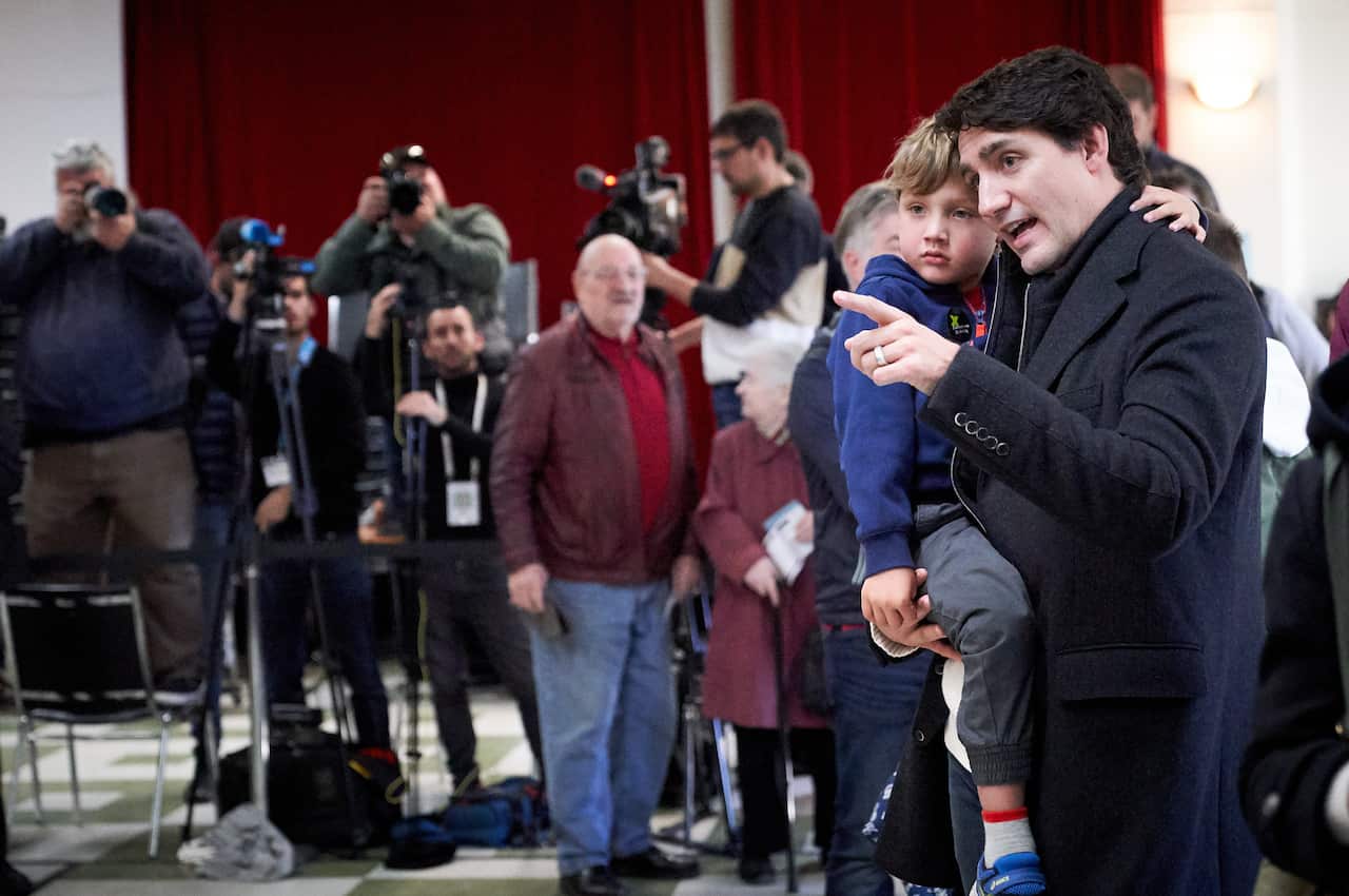 epa07938853 Canadian Prime Minister and Liberal Party leader Justin Trudeau wait in line with his son Hadrien at the polling station during the country's 43rd general election day in Montreal, Quebec, Canada, 21 October 2019. EPA/VALERIE BLUM
