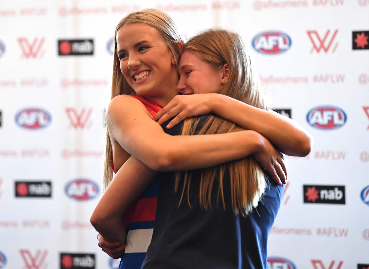 Gabby Newton of the Western Bulldogs (L) and IIsabella Grant embrace after they were both picked to play at the Western Bulldogs in the 2019 AFL Womens Draft.