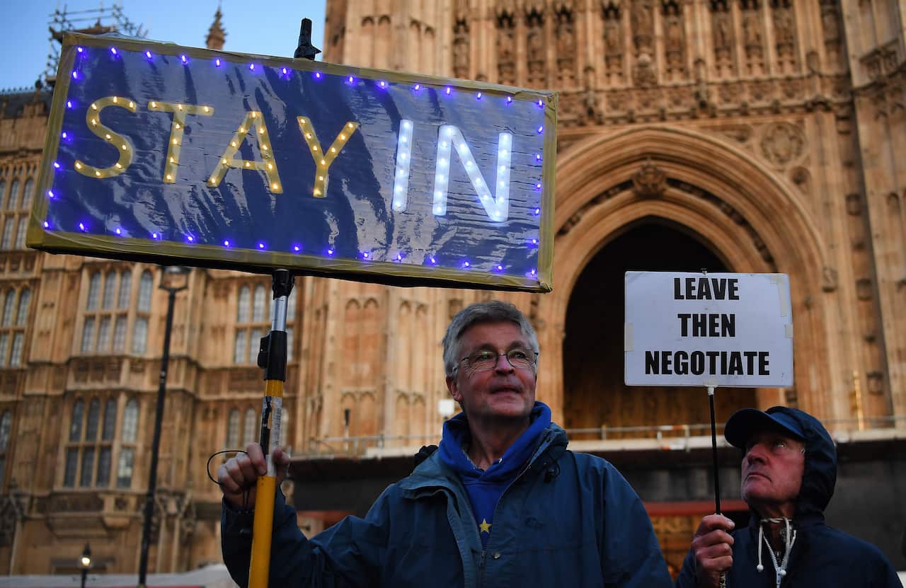 Pro-EU and Pro-Leave campaigners wait outside Parliament in London, Britain. 