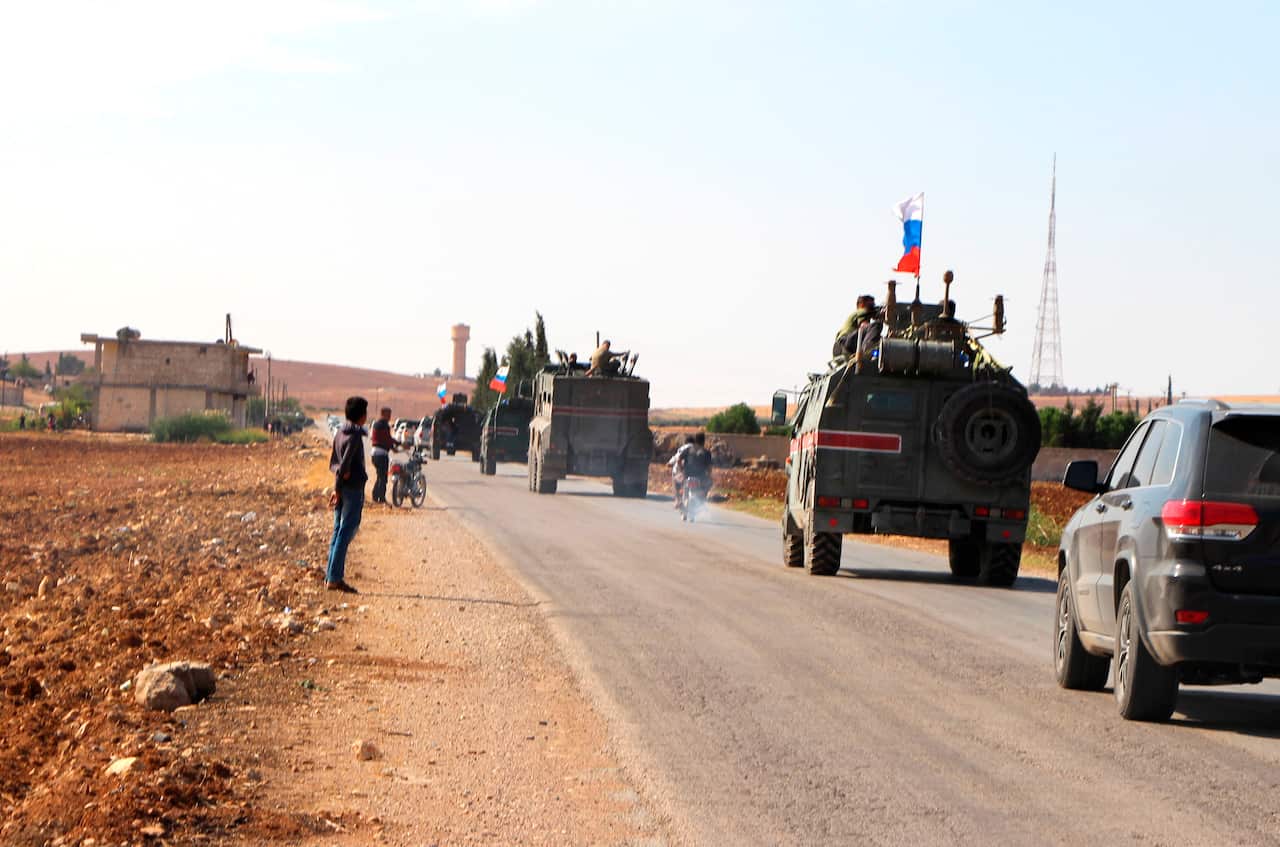 Russian forces armored vehicles patrol the Syrian border in Kobani.