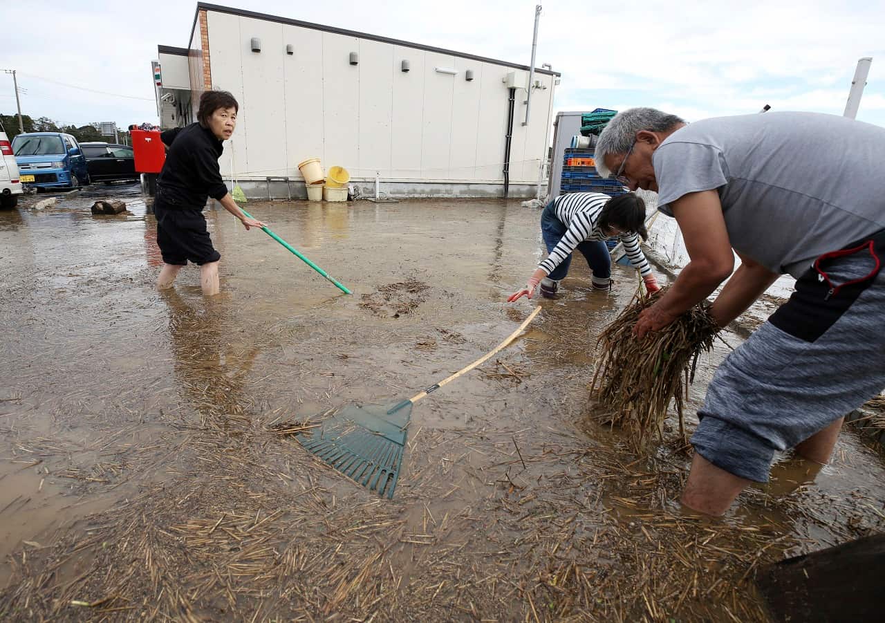 People clean up after the flooding in Chiba Prefecture.