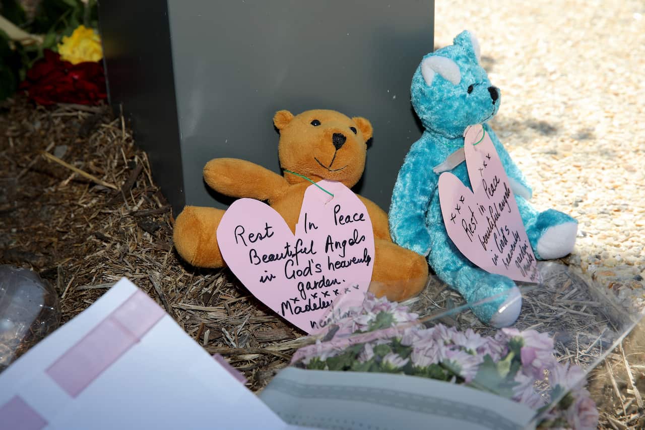 Tributes to the girls are seen near the crime scene in Bogdanich Way, Madeleyin, Perth on 27 October, 2019. 