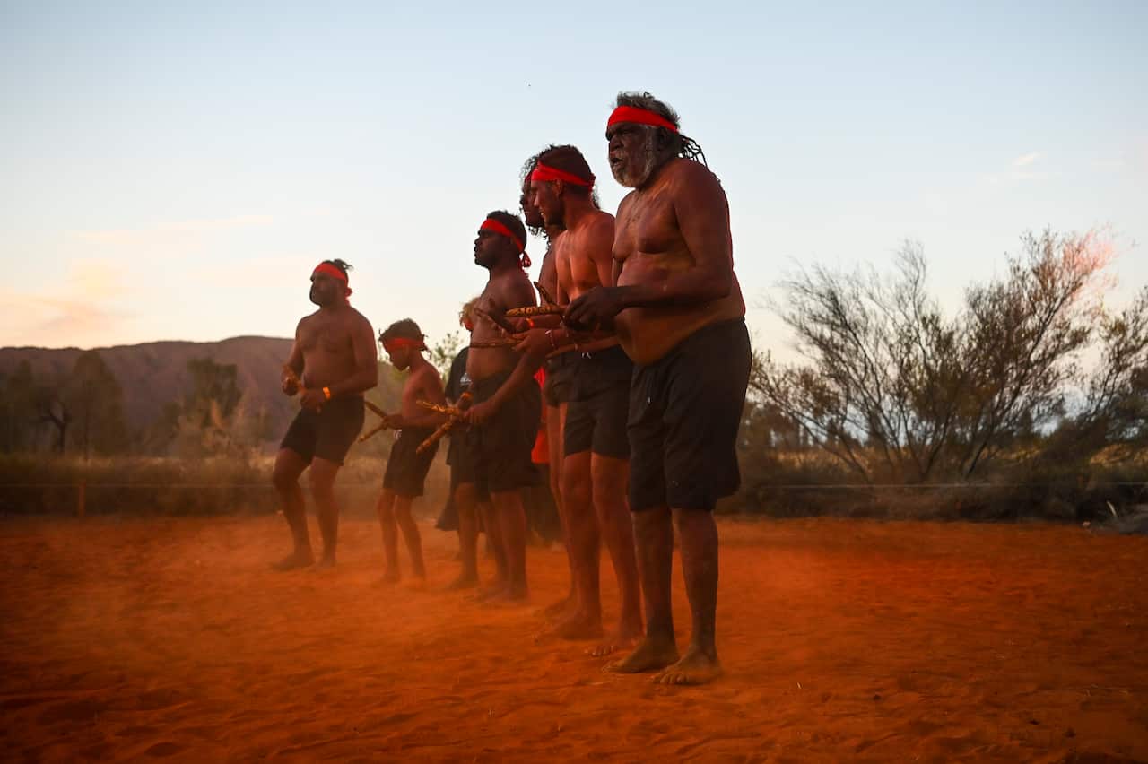 Traditional dancers perform during the official ceremony to celebrate the closure of the climb at Uluru-Kata Tjuta National Park in the Northern Territory, Sunday, October 27, 2019.  (AAP Image/Lukas Coch) NO ARCHIVING