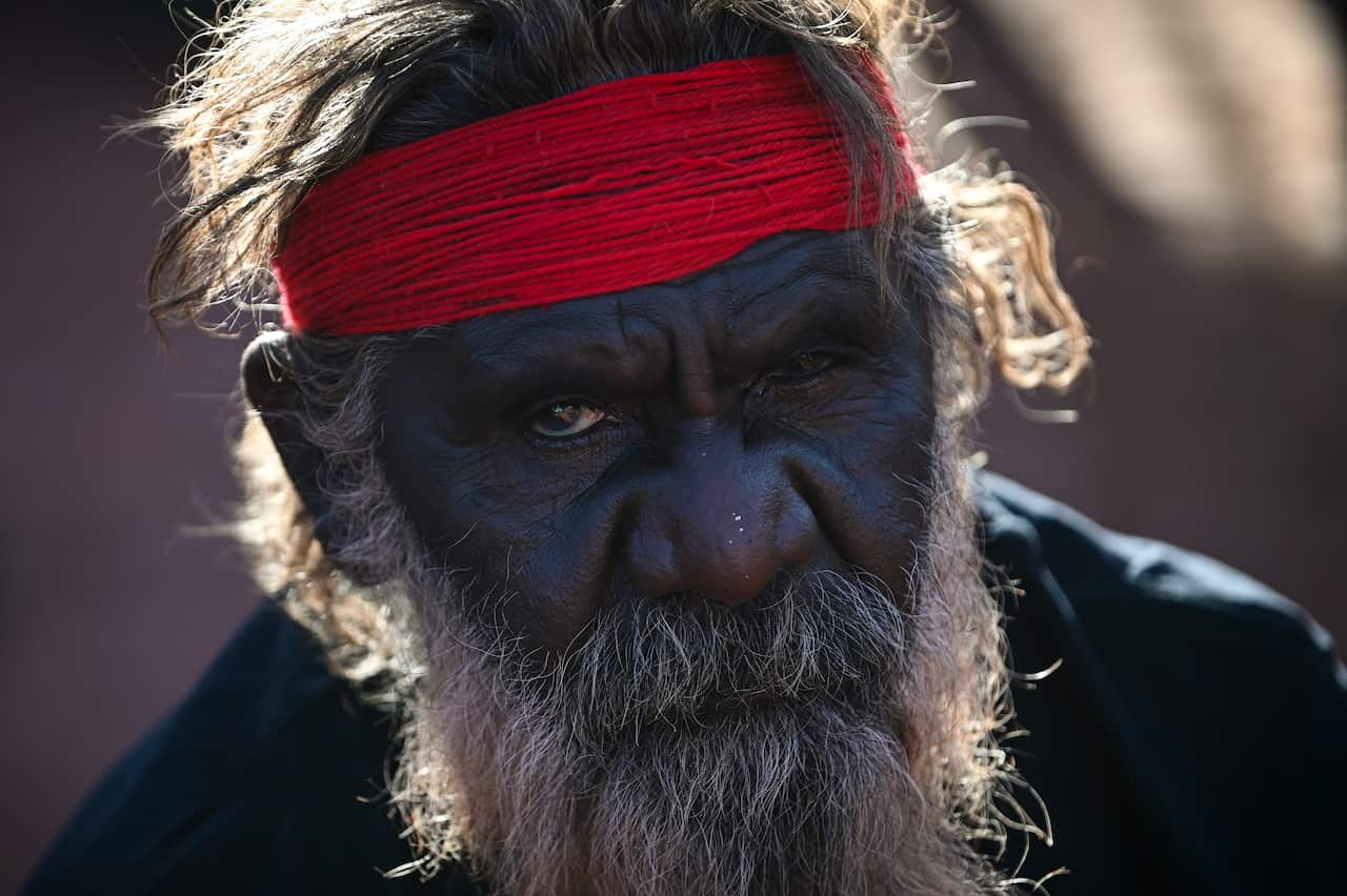 A traditional owner is seen during the official ceremony to celebrate the closure of the climb at Uluru-Kata Tjuta National Park in the Northern Territory, Sunday, October 27, 2019.  (AAP Image/Lukas Coch) NO ARCHIVING