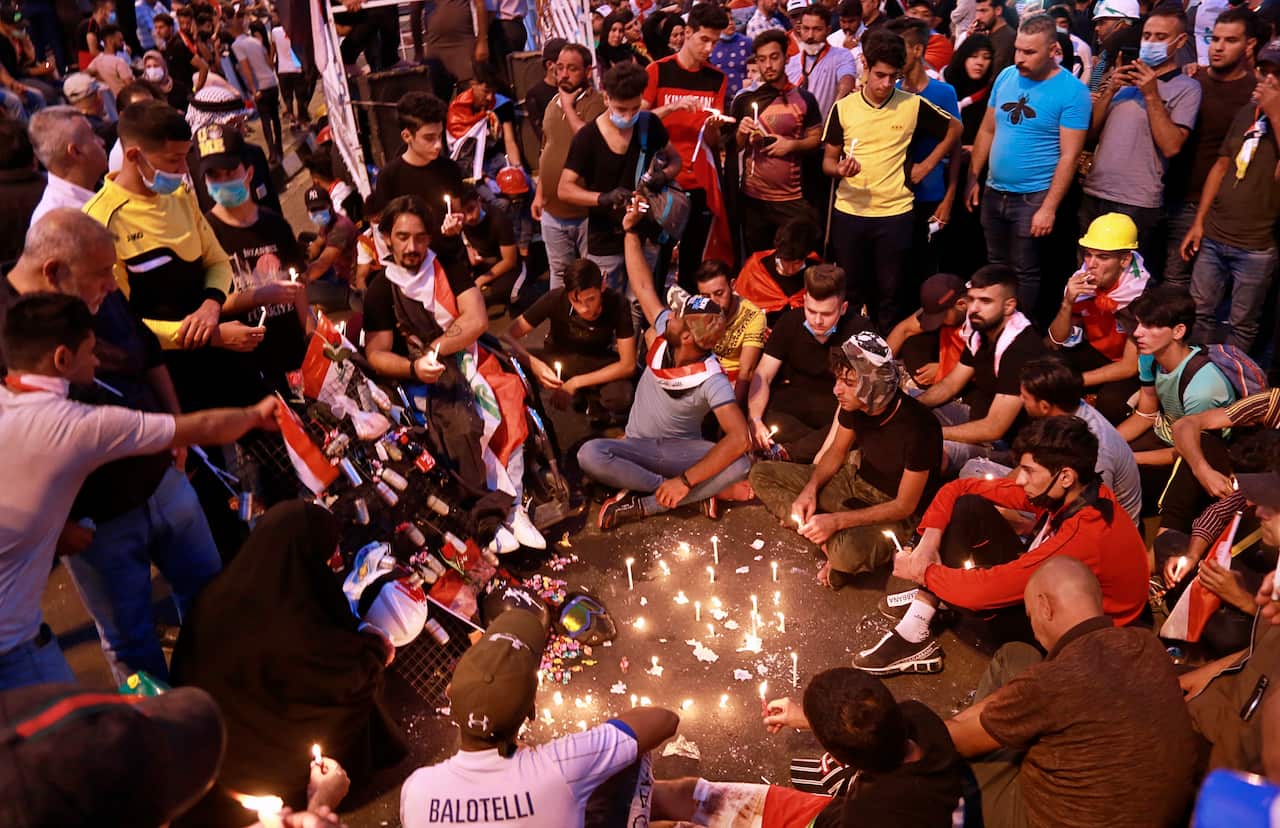 Anti-government protesters light candles for the slain protesters in Tahrir Square during ongoing anti-government protests in Baghdad, Iraq, Sunday, Nov. 3, 2019. (AP Photo/Khalid Mohammed)