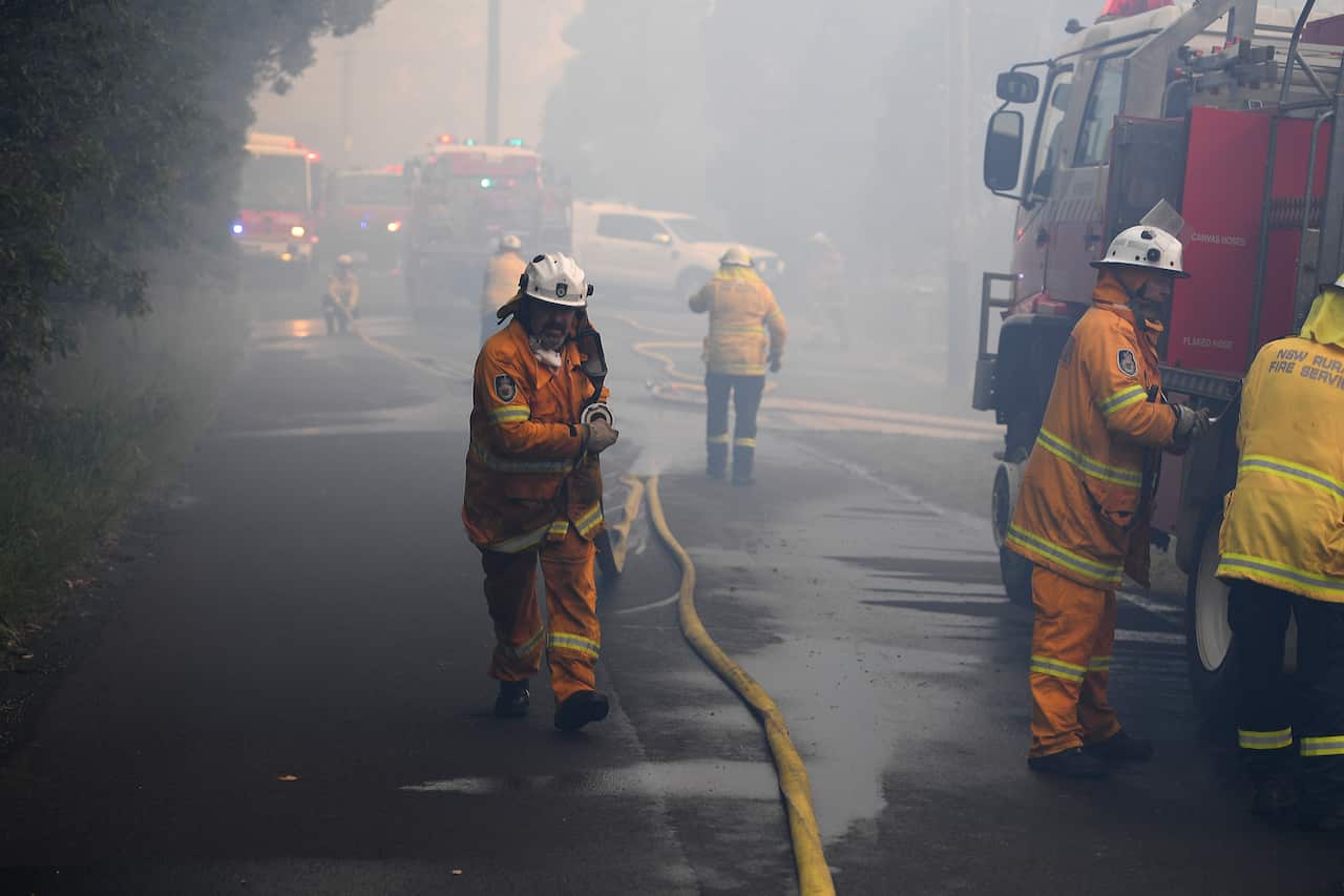 NSW Rural Fire Service personnel conduct property protection as a bushfire burns in Woodford NSW, Friday, November 8, 2019. Hot, windy conditions are wreaking havoc as bushfires burn out of control across parts of NSW, with 14 current emergency warnings i