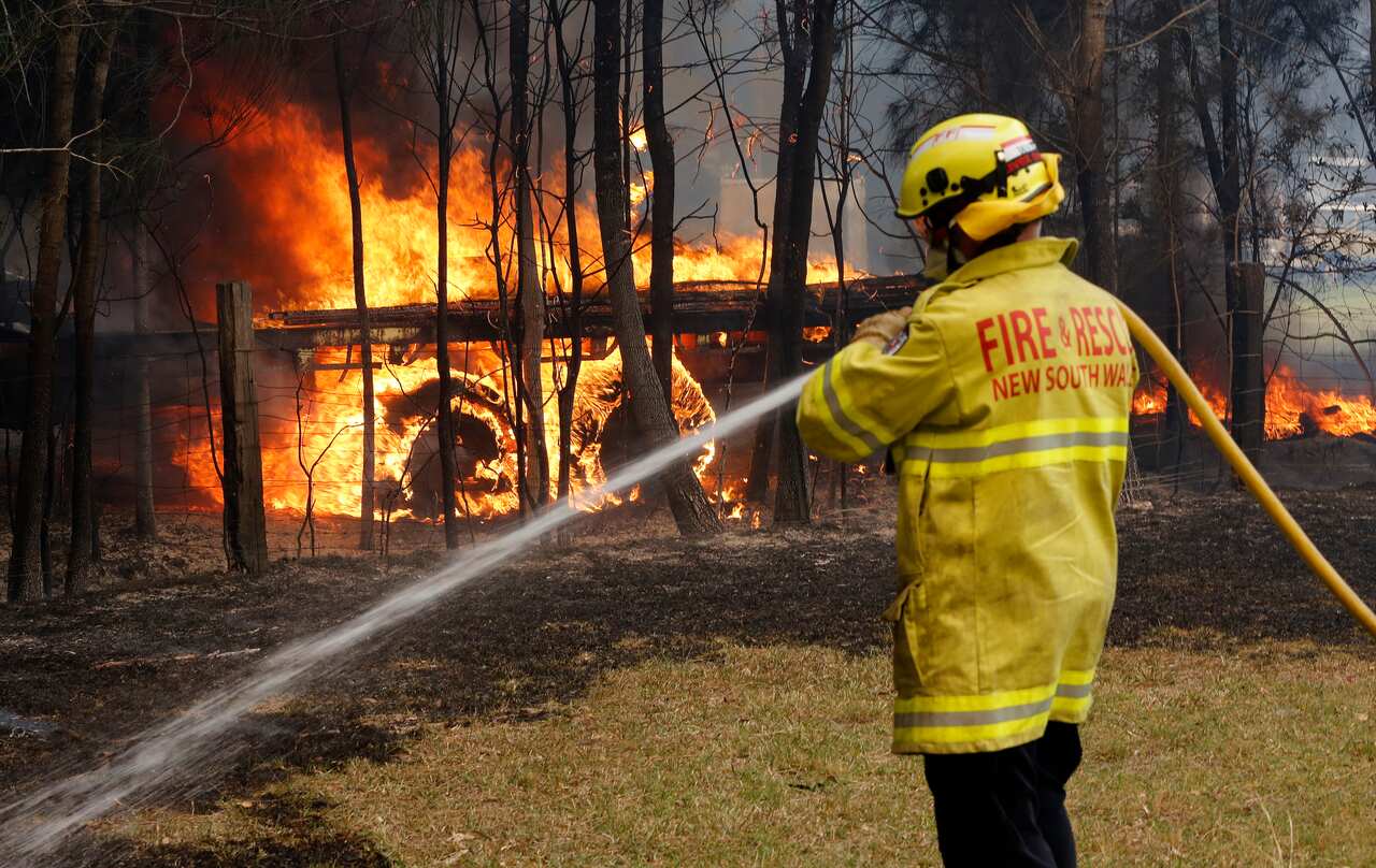 Firefighters battle a blaze at Old Bar on Saturday.