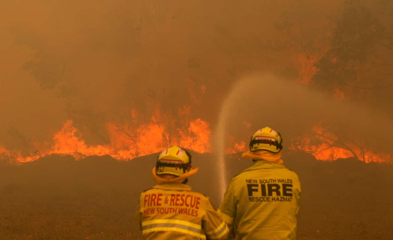 Firefighters work to contain a bushfire