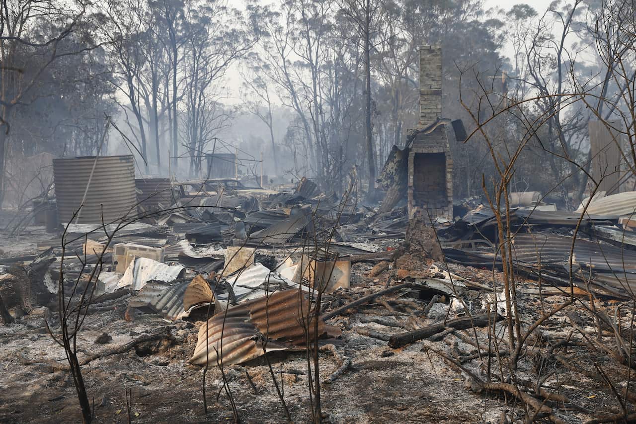 The ruins of a house smoulders near Taree.
